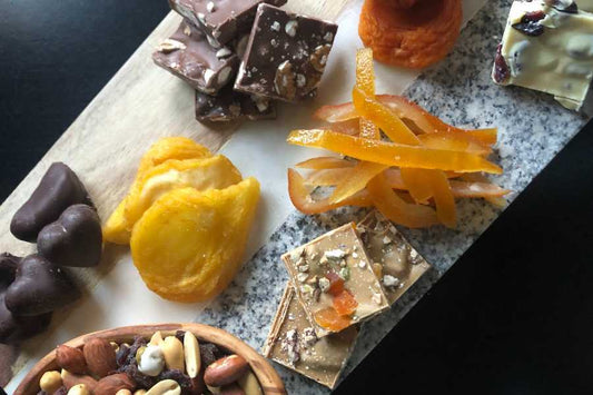 plate with dried fruits, chocolate and nuts