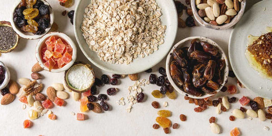 oats, dried fruits and nuts in different plates