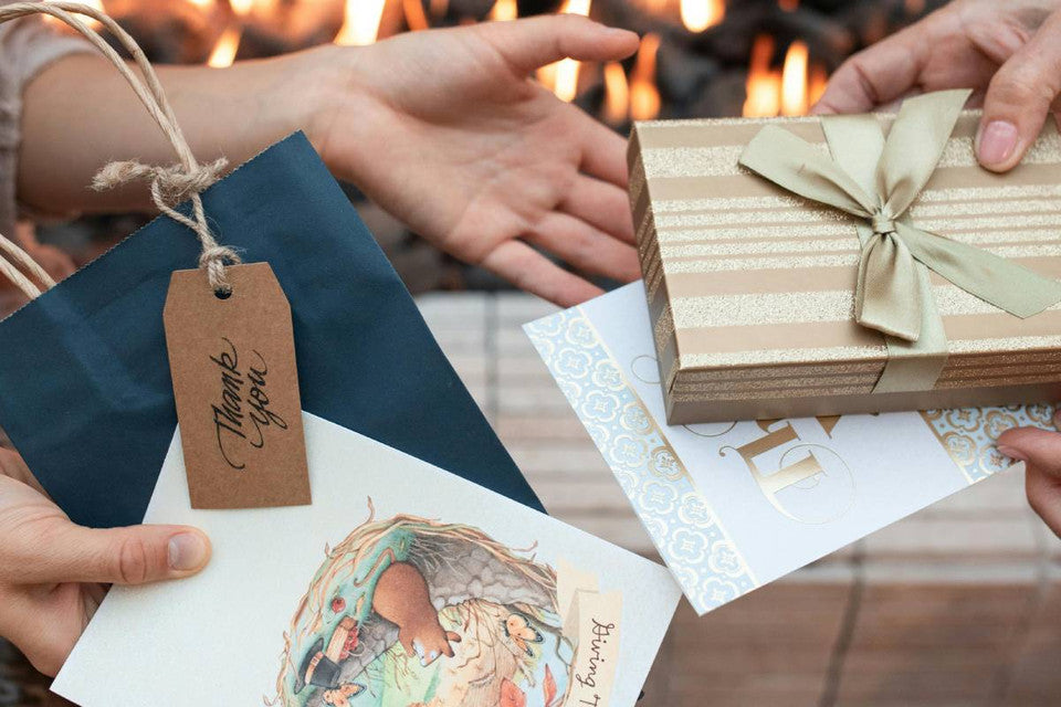 one giving gift box to onother as thank you